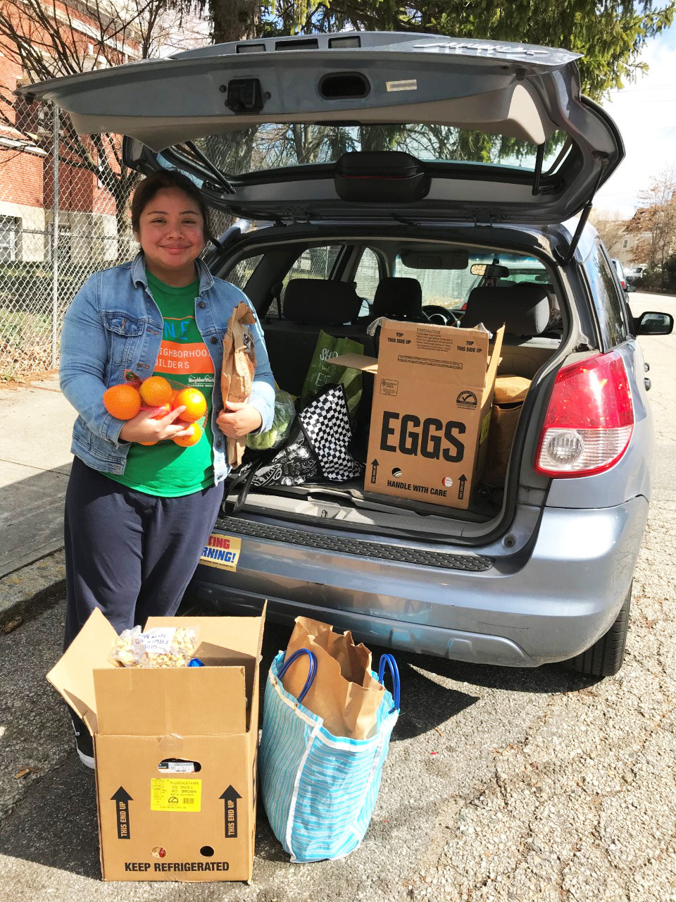 An older photograph of ONE Neighborhood Builders Community Health Worker Yuselly Mendoza, who volunteers some of her time at the Federal Hill House Food Pantry, which has been a key source of food for our community members.